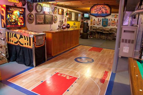 Basement arcade room with pinball machine